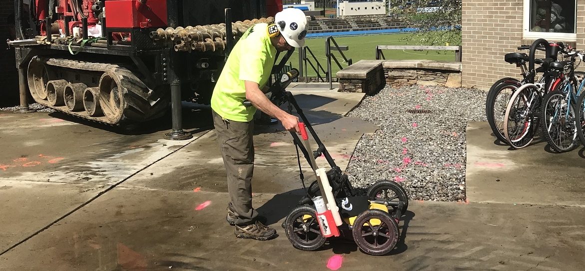 Technician using GPR to mark underground utilities