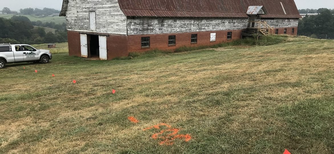 Orange paint and flagging indicate location of fiber optic cable.