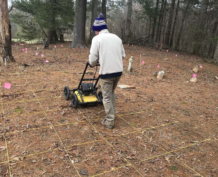 Technician pushing GPR-cart over suspected slave cemetery