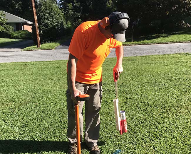 Technician locating residential water line